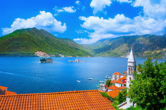 Harbor and ancient buildings in sunny day at Boka Kotor bay (Boka Kotorska), Montenegro, Europe. 