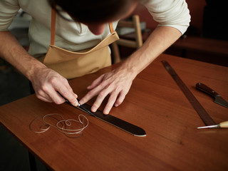 Chamfering with a leather belt by a tanner.