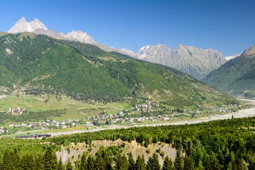 Fototapeta na wymiar Mestia village on the background of the picturesque Caucasus mountains. The Svaneti region is a popular tourist region in Georgia