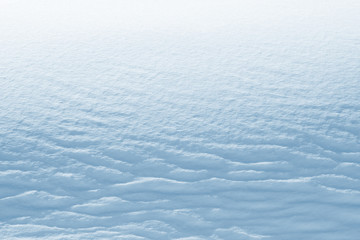 Fresh snow background texture. Winter background with snowflakes and snow mounds.