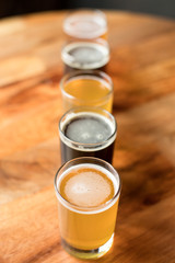 Overhead on a pale ale with a flight of beer arranged in a straight row