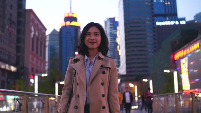 Pretty young asian woman walking in the street in slow motion