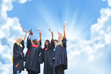 education, graduation and people concept - silhouettes of many happy students in gowns throwing...