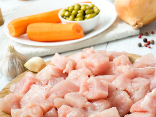 Sliced chicken meat for cooking Vegetables on table