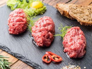 Steak tartare served with capers, pickled cucumbers and chopped onion.