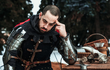 thoughtful male knight in historical clothing