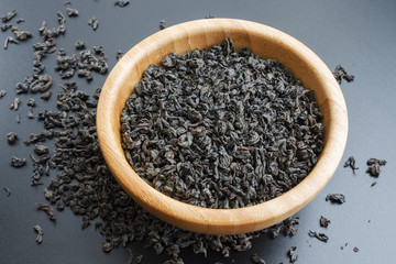 black tea leaves in a wooden bowl