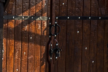 wooden brown red gates, doors closed to the hinged castle