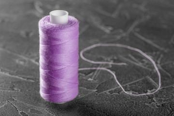 sewing thread on a bobbin of lilac color