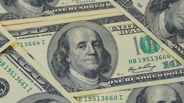 Hundred-dollar bills close-up, motion slider - 119. Macro photography of banknotes. Portrait of Benjamin Franklin.