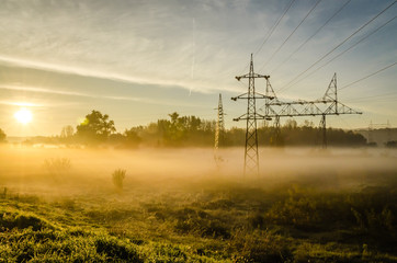 electric transmission tower in the morning mist 