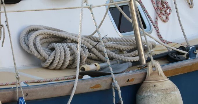 Strong Old-Fashioned Rustic Rope on The Deck of a Boat  in Marina, Close Up View - DCi 4K Resolution
