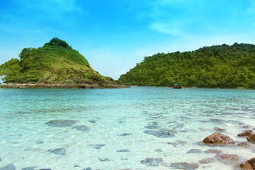 Fototapeta premium mountains and sea against a blue sky with clouds on a sunny day.