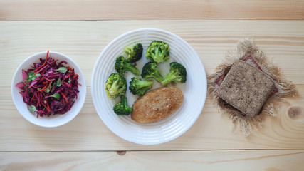Vegetarian diet. Cutlets with broccoli and salad with red cabbage, apples and nuts.
