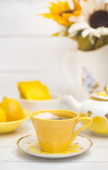 Bright Yellow Tea Set on a White Wood Table