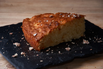 A piece of apple pie with grated chocolate near chocolate truffle candies. Selective focus and small depth of field.