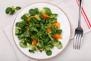 Dietary lunch: gentle salad Korn with pine nuts and tangerine. Dish for vegetarians, top view