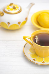 Bright Yellow Tea Set on a White Wood Table