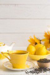 Bright Yellow Tea Set on a White Wood Table