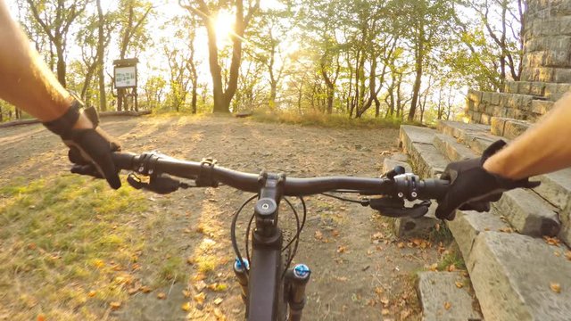 Mountain biking first person point of view on bike trail in summer woods. Cycling downhill in forest. Extreme speed riding, first person perspective view POV. Gimbal stabilized video GOPRO HERO4 4K.