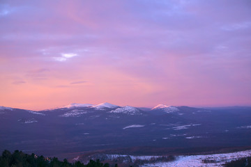 landscape - pink sky over the winter Ural mountains in the early morning
