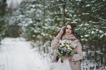 The bride against the winter snow-covered forest of firs and pines 847.