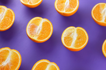 Sliced fruit oranges in checkered pattern on a purple background, symmetrically laid out citrus in pop art style, fruit pattern of halves of oranges, ultraviolet, minimalism