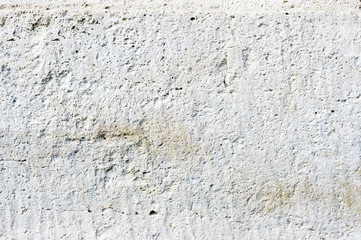 Close-up Deep texture of white-painted porous stone on the facade of the building. Stoned wall background texture
