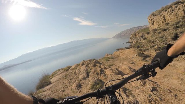 Man riding enduro mountain bike on rocky trail. View from first person perspective POV. Gimbal stabilized video. Shot with GOPRO HERO4 4K.