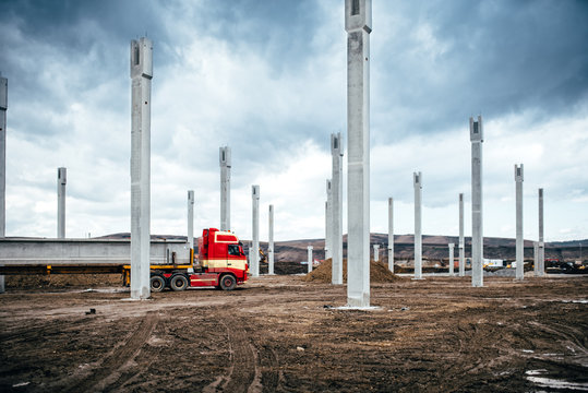 Truck carrying and transporting prefabricated materials and elements on construction site