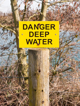 yellow and black sign danger deep water lake