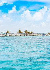 View of boats in the port of Male, Maldives. Copy space for text. Vertical.