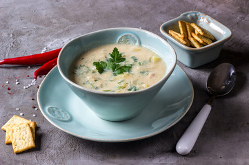 Chicken and potato chowder soup with green in bowl