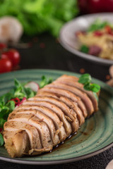 Chicken steak roasted and salad, food photography. Black background. Top view
