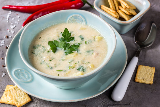 Chicken and potato chowder soup with green in bowl