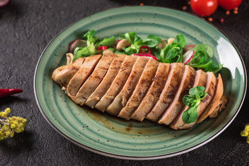 Chicken steak roasted and salad, food photography. Black background. Top view