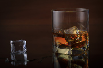 A Glass Of whiskey with ice and gold light