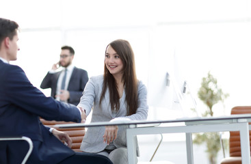 business woman shaking hands with a business partner.