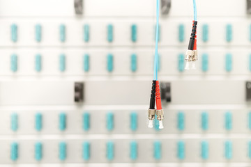 Fiber optic connectors with patch-panel on the background, server room, technology