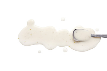 splashes and spilled ranch dressing with a spoon.  isolated on white background. flat lay, top view
