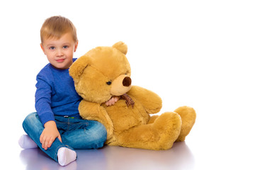 Little boy playing with teddy bear