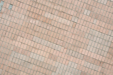 Old Soviet beige wall tiles. The texture of the classical outer tile, which was revetted by...