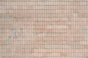 Old Soviet beige wall tiles. The texture of the classical outer tile, which was revetted by...