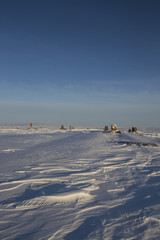 Standing stones found along an arctic landscape with snow on the ground, near Arviat Nunavut Canada