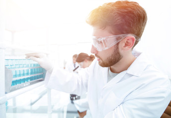 side view of focused scientist holding test tube in laboratory