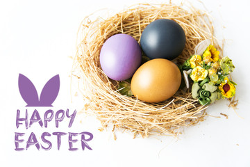 Multi-colored Easter eggs in nest on wooden background, selective focus image. Happy Easter card 