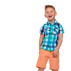 A cute little boy in a shirt and shorts.
