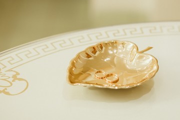 Wedding rings in golden cup before ceremony