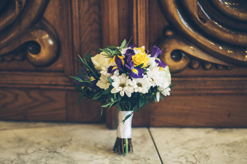 iris flower wedding bouquet near the wooden door on the floor