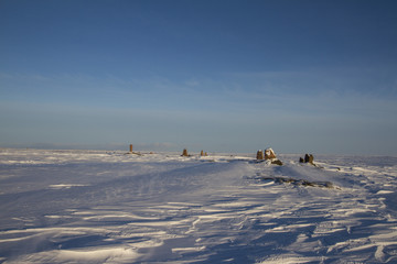Standing stones found along an arctic landscape with snow on the ground, near Arviat Nunavut Canada
